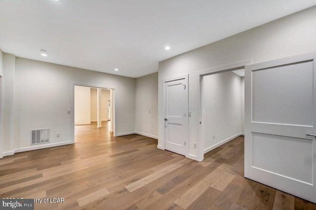 spare room featuring light hardwood / wood-style flooring