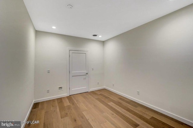 spare room with light hardwood / wood-style flooring