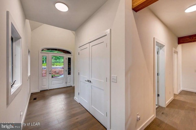 corridor featuring beamed ceiling and hardwood / wood-style floors