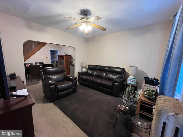 carpeted living room featuring radiator heating unit and ceiling fan