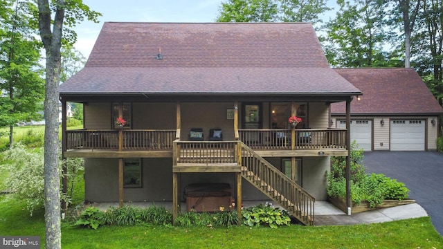 rear view of house featuring a garage