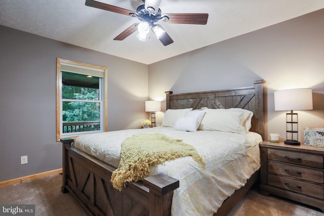 bedroom with ceiling fan and dark carpet