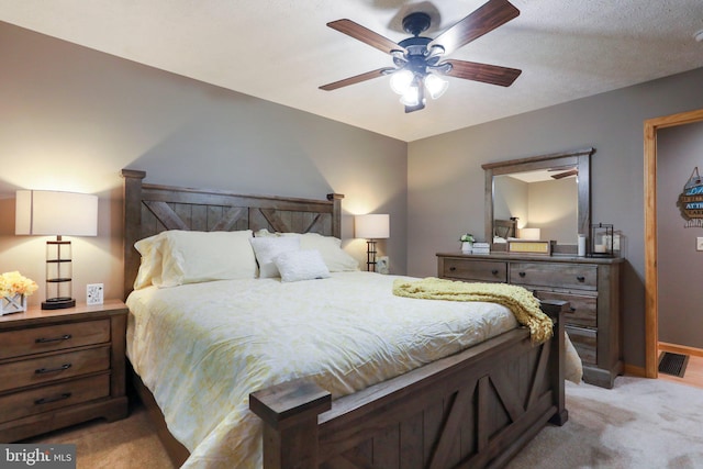 bedroom featuring light carpet and ceiling fan