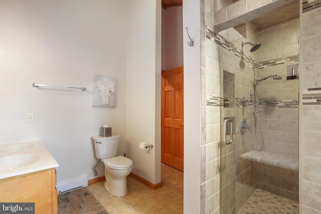 bathroom with toilet, an enclosed shower, vanity, tile patterned flooring, and a baseboard heating unit