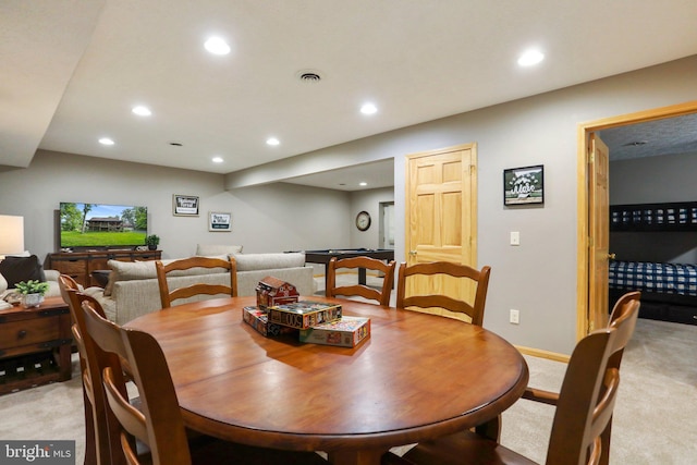 dining space with light colored carpet