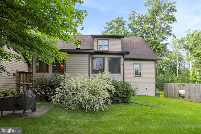 rear view of house with a lawn