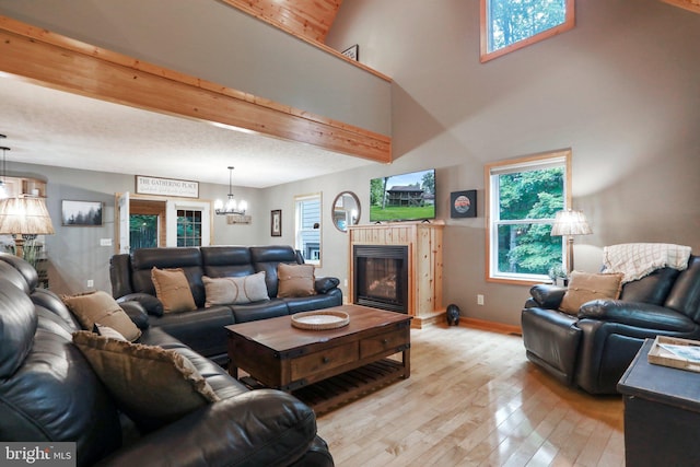 living room with a chandelier and light wood-type flooring