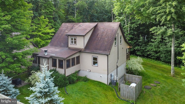 exterior space featuring a yard and a sunroom