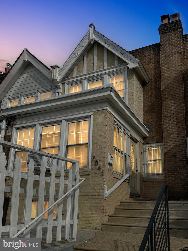 view of back house at dusk