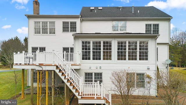 rear view of property with a wooden deck