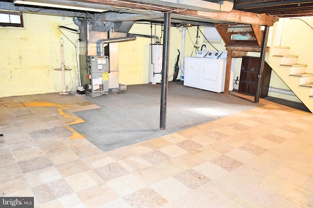 basement with water heater, washing machine and dryer, and heating unit