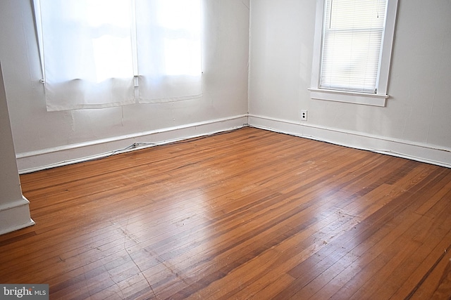 spare room with hardwood / wood-style floors