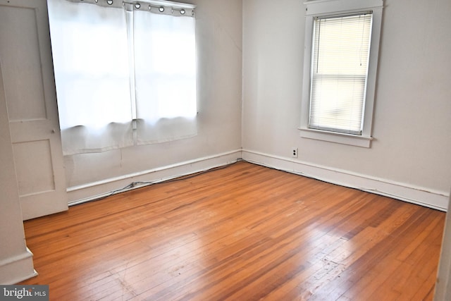 unfurnished room with hardwood / wood-style flooring