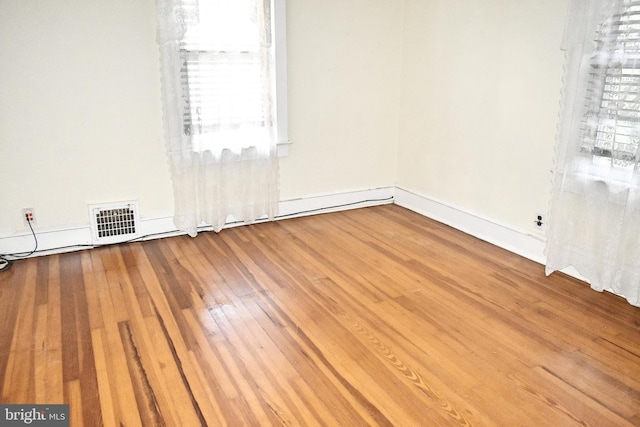 unfurnished room with hardwood / wood-style flooring