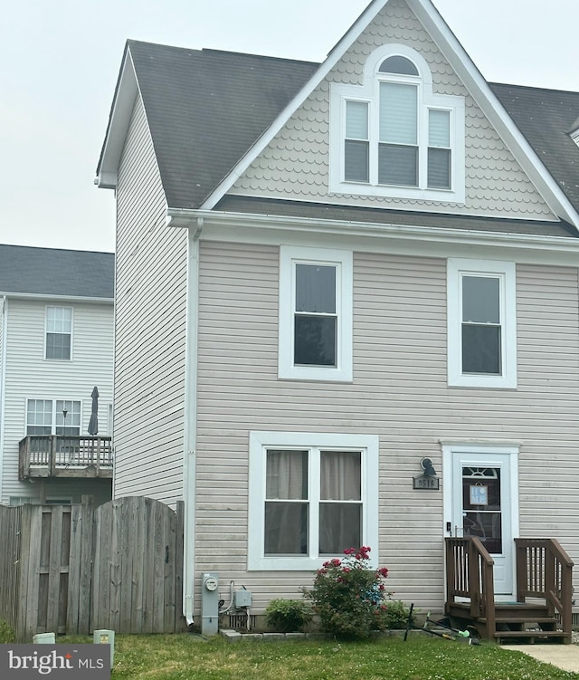 rear view of property with fence