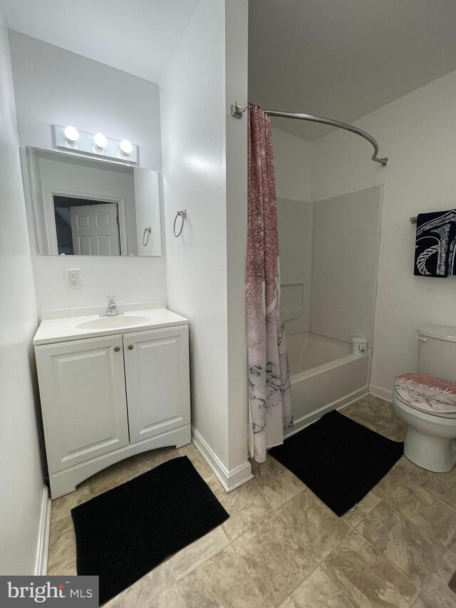 full bath featuring vanity, toilet, baseboards, and shower / bath combo