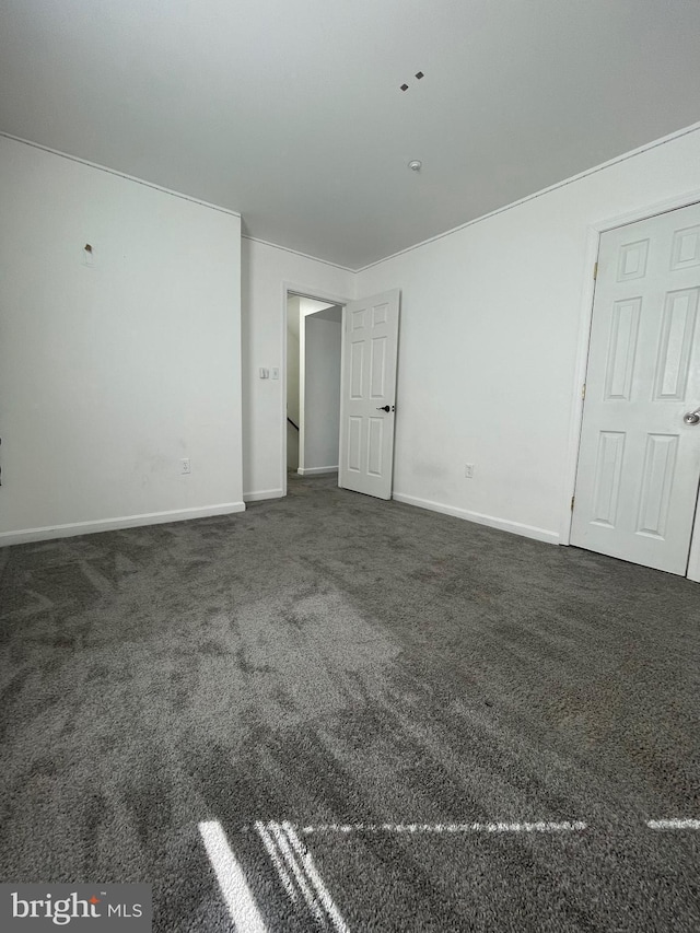 unfurnished bedroom with baseboards and carpet floors