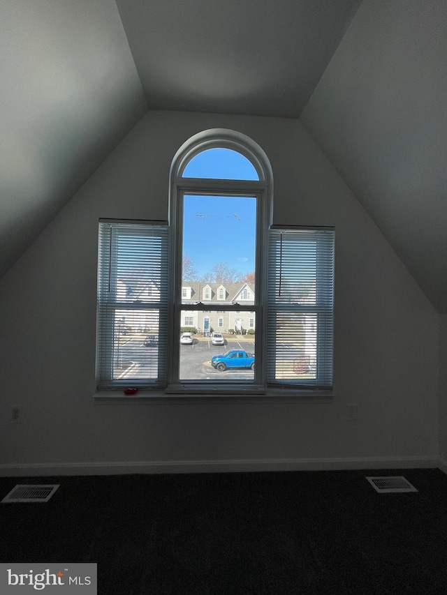 bonus room featuring lofted ceiling, baseboards, and visible vents