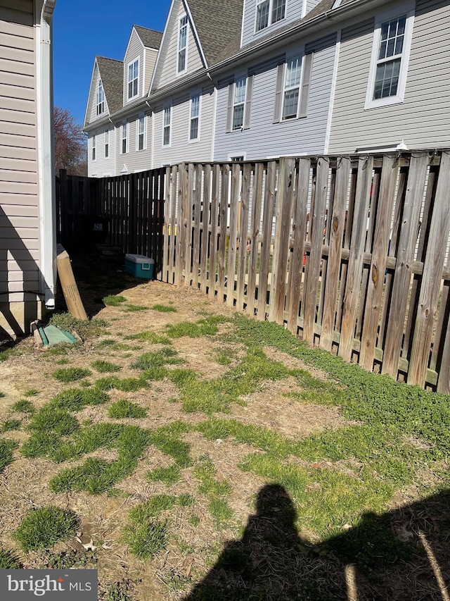 view of yard featuring a carport and fence