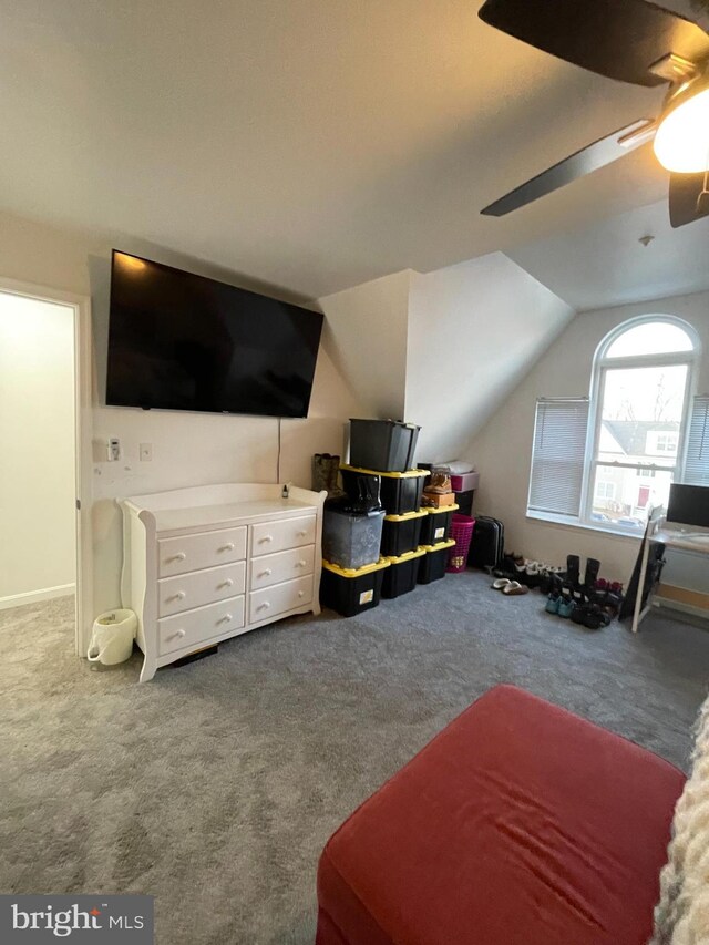 carpeted bedroom featuring lofted ceiling and a ceiling fan