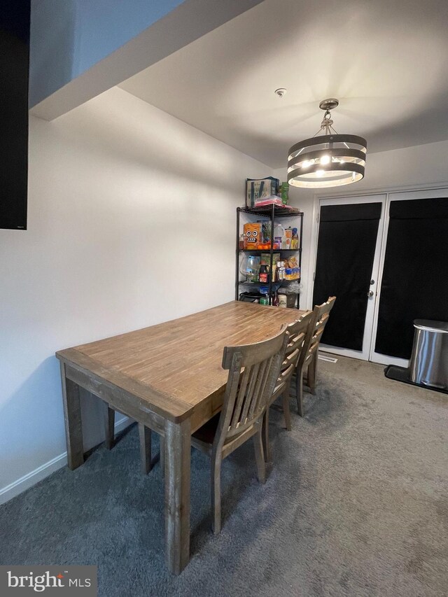 unfurnished dining area featuring carpet flooring and baseboards