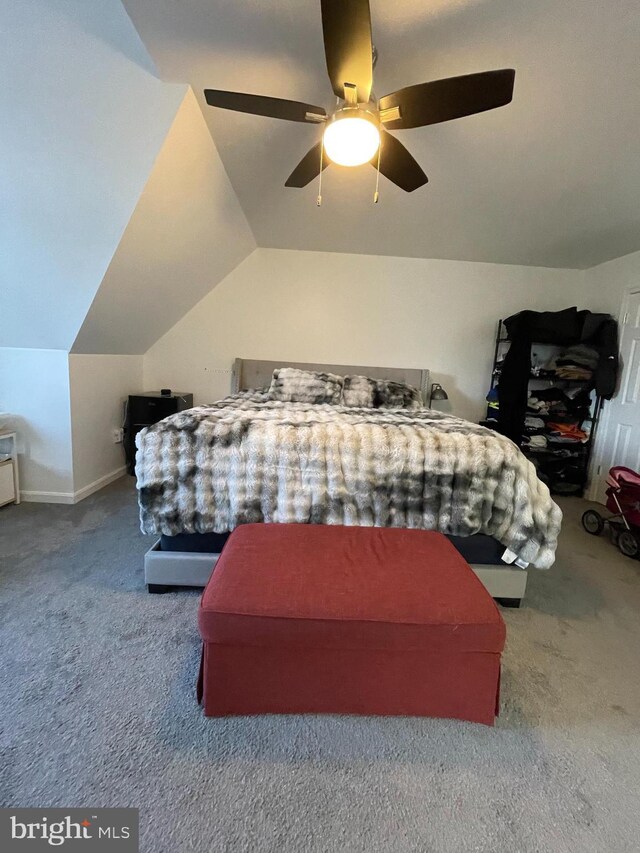 bedroom featuring vaulted ceiling, a ceiling fan, baseboards, and carpet floors