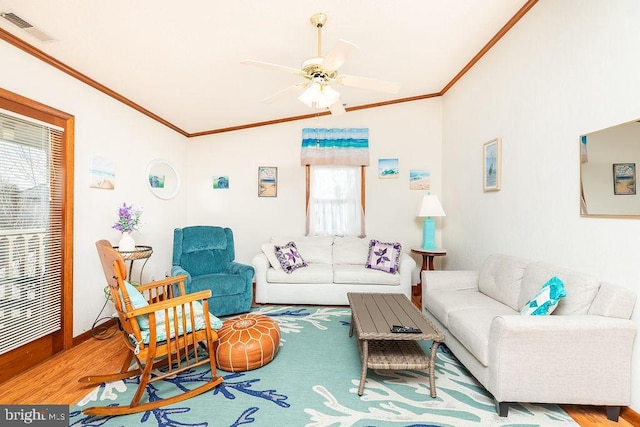 living room featuring lofted ceiling, crown molding, wood-type flooring, and ceiling fan