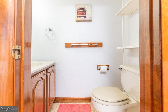 bathroom with vanity, tile patterned floors, and toilet