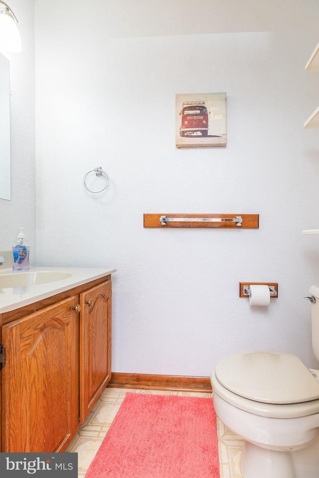 bathroom featuring vanity and toilet