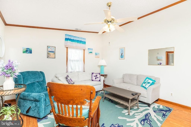 living room with ceiling fan, ornamental molding, and hardwood / wood-style floors