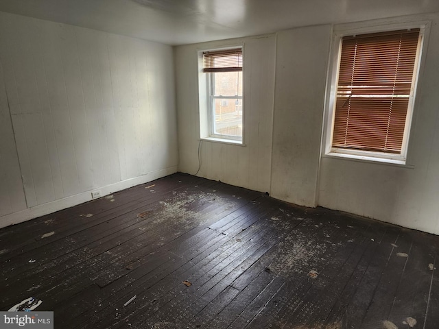 empty room with dark wood-type flooring