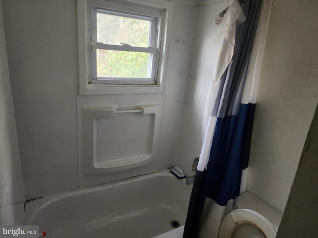 bathroom featuring walk in shower and toilet