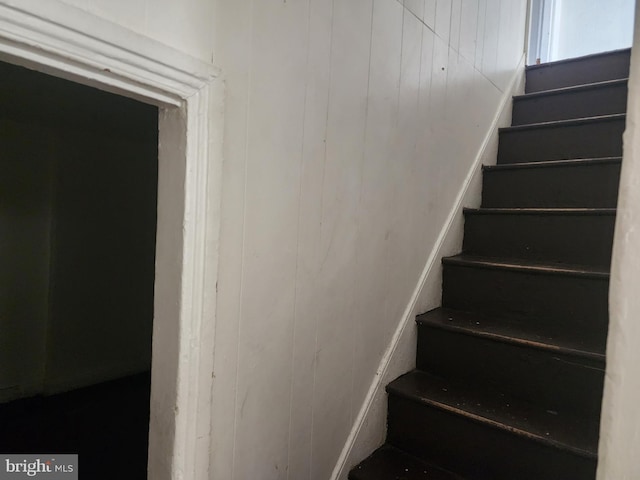 stairs with wood walls