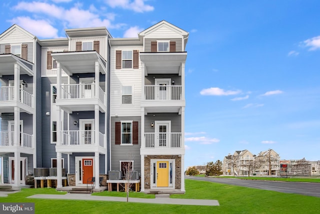 14302 Sinepuxent Ave Unit D, Ocean City, MD 21842 - view of property featuring a residential view, stone siding, and a front lawn