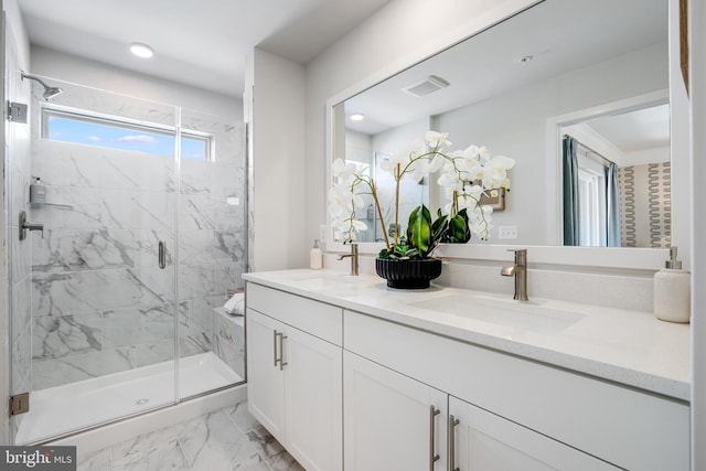 bathroom with marble finish floor, double vanity, a sink, and a marble finish shower