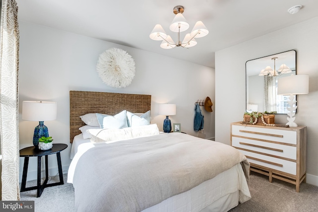 bedroom with an inviting chandelier and light colored carpet