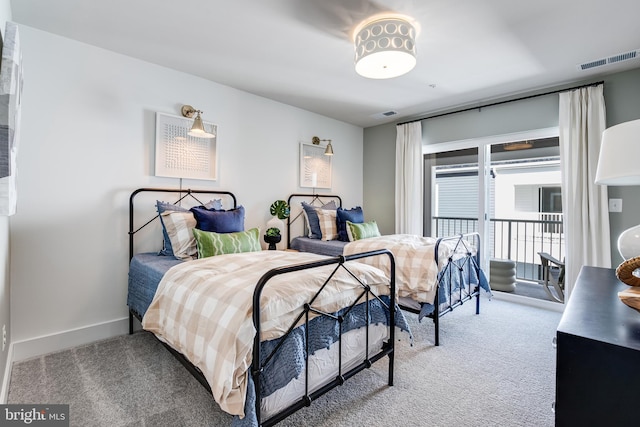 carpeted bedroom with access to outside, visible vents, and baseboards