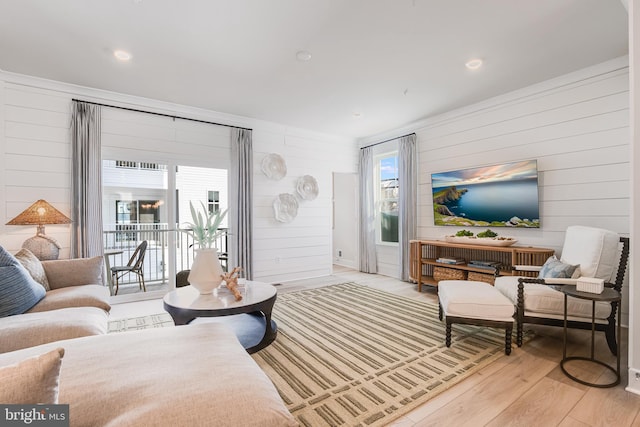 living area featuring light wood-type flooring and recessed lighting