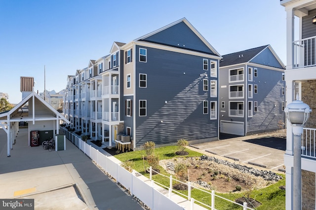 view of property featuring a residential view and fence