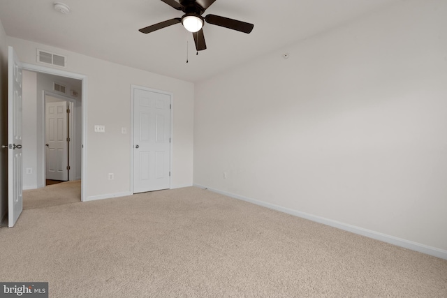 unfurnished bedroom with light carpet, baseboards, visible vents, and ceiling fan