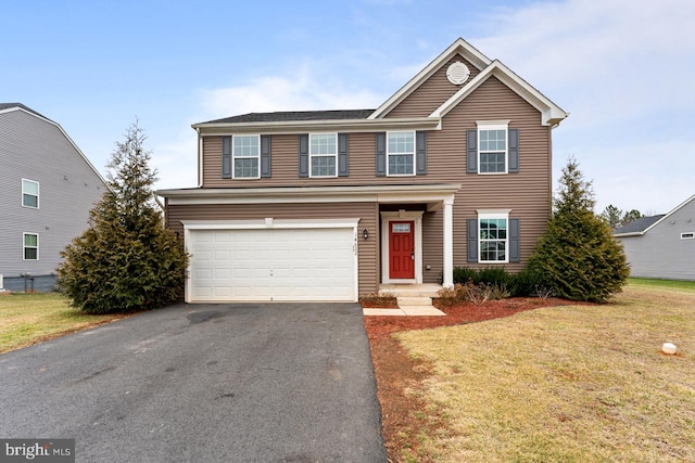 view of property with a garage and a front lawn