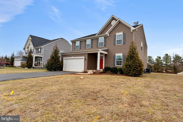 view of front of home featuring cooling unit, a garage, and a front lawn