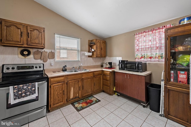 kitchen with light tile patterned flooring, lofted ceiling, sink, stainless steel electric range, and backsplash