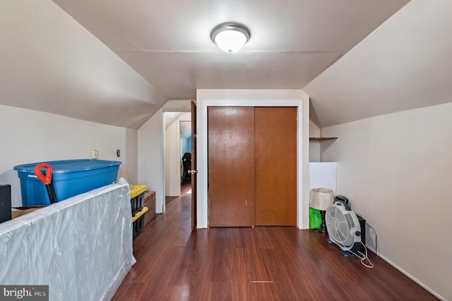 additional living space with dark hardwood / wood-style flooring and lofted ceiling