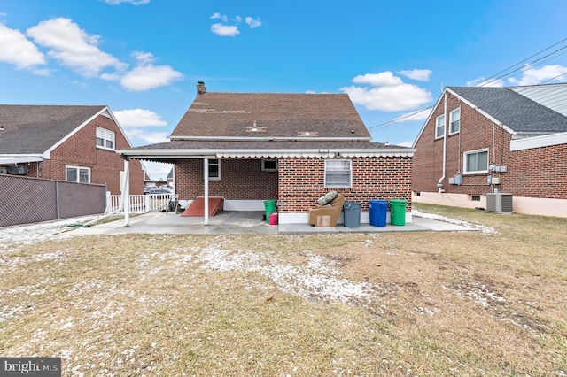 back of house with a lawn, central AC unit, and a patio area