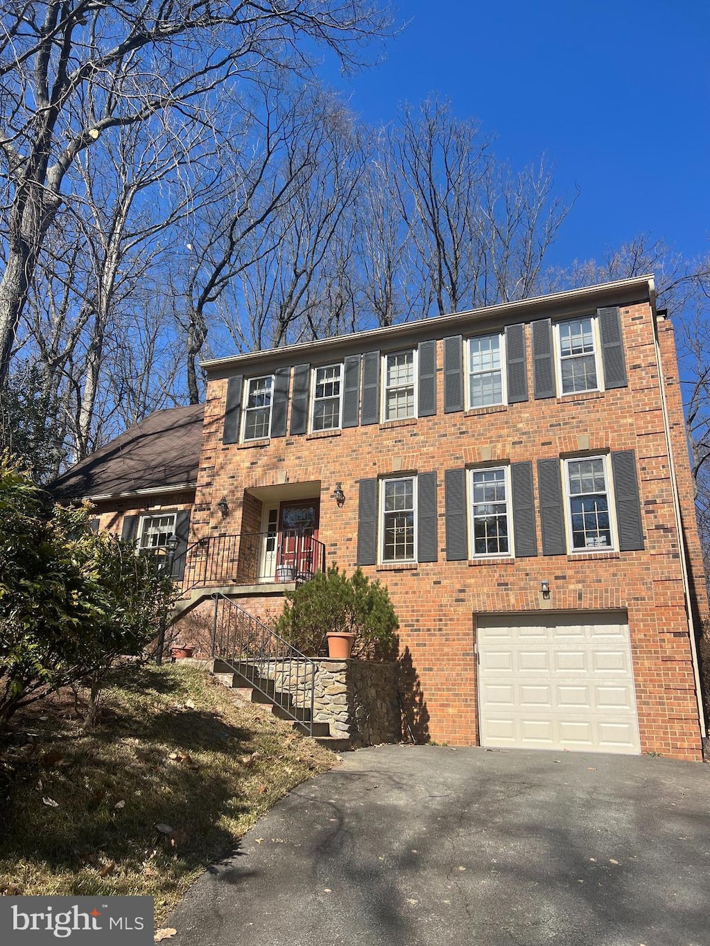 11506 Purple Beech Dr, Reston, VA 20191 - view of front of home with brick siding, an attached garage, and aphalt driveway