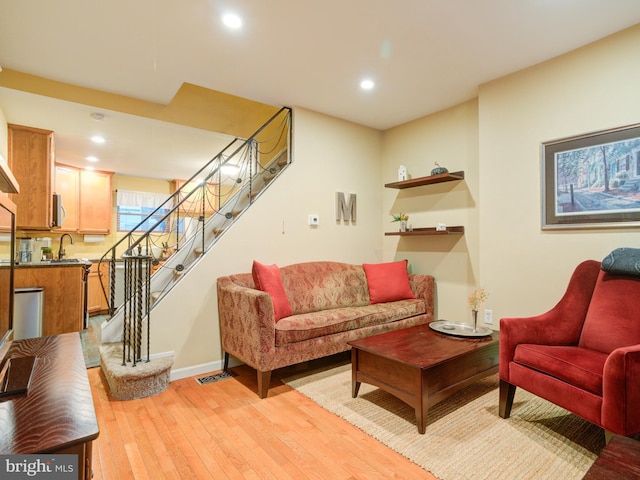 living room featuring sink and light wood-type flooring