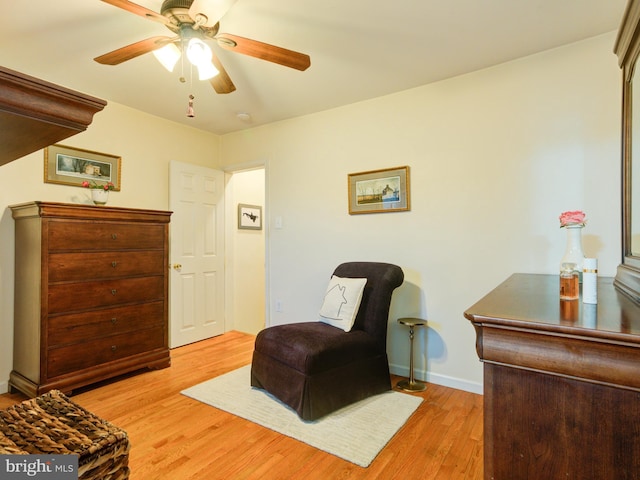 sitting room featuring ceiling fan and light wood-type flooring