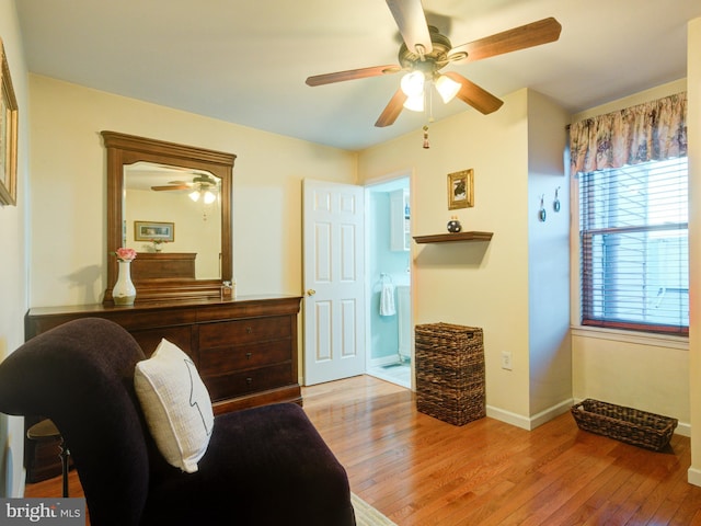 sitting room with ceiling fan and light wood-type flooring