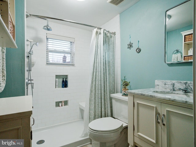 bathroom featuring vanity, toilet, and curtained shower